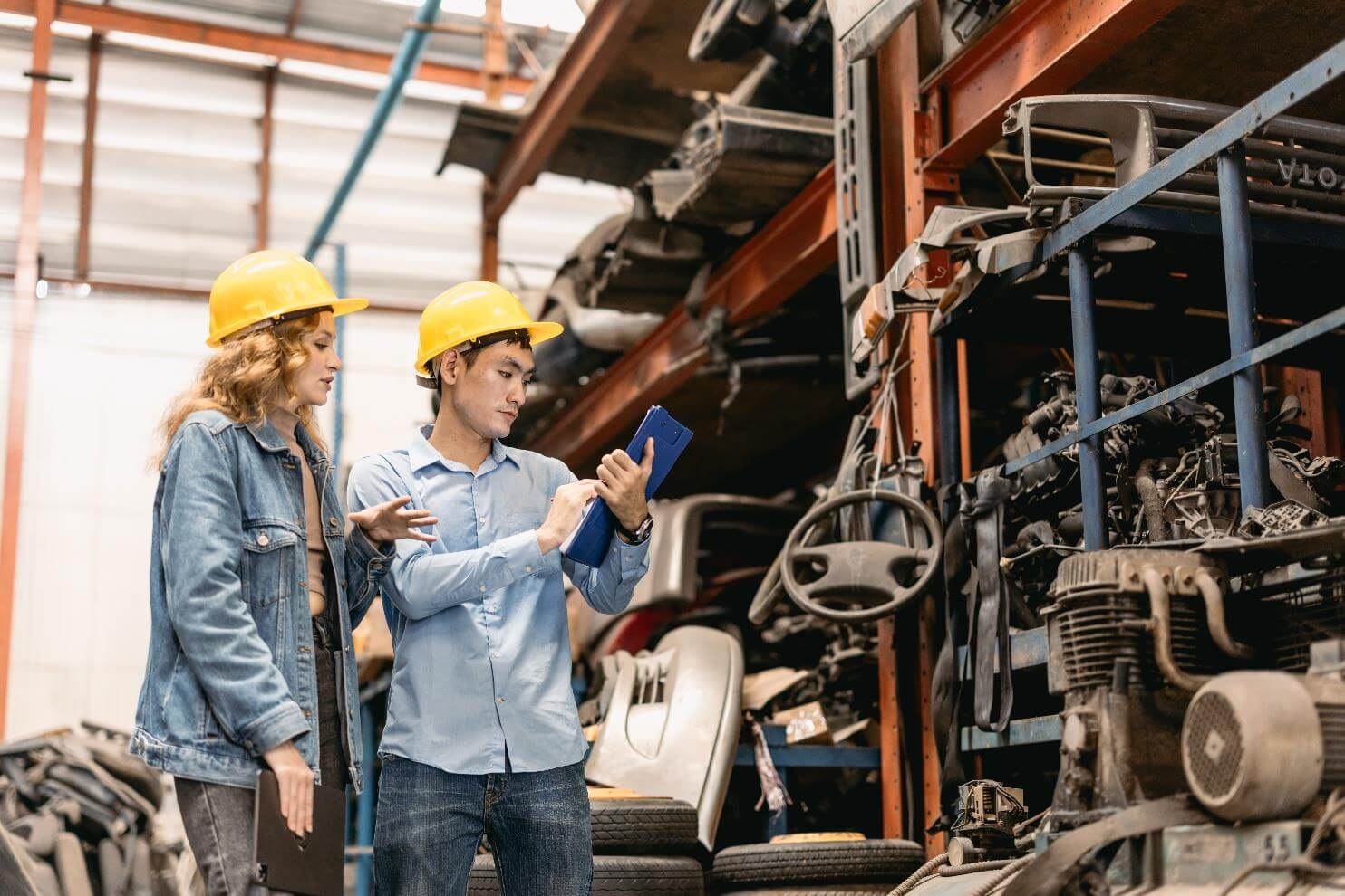Workers inspecting machinery in a warehouse.