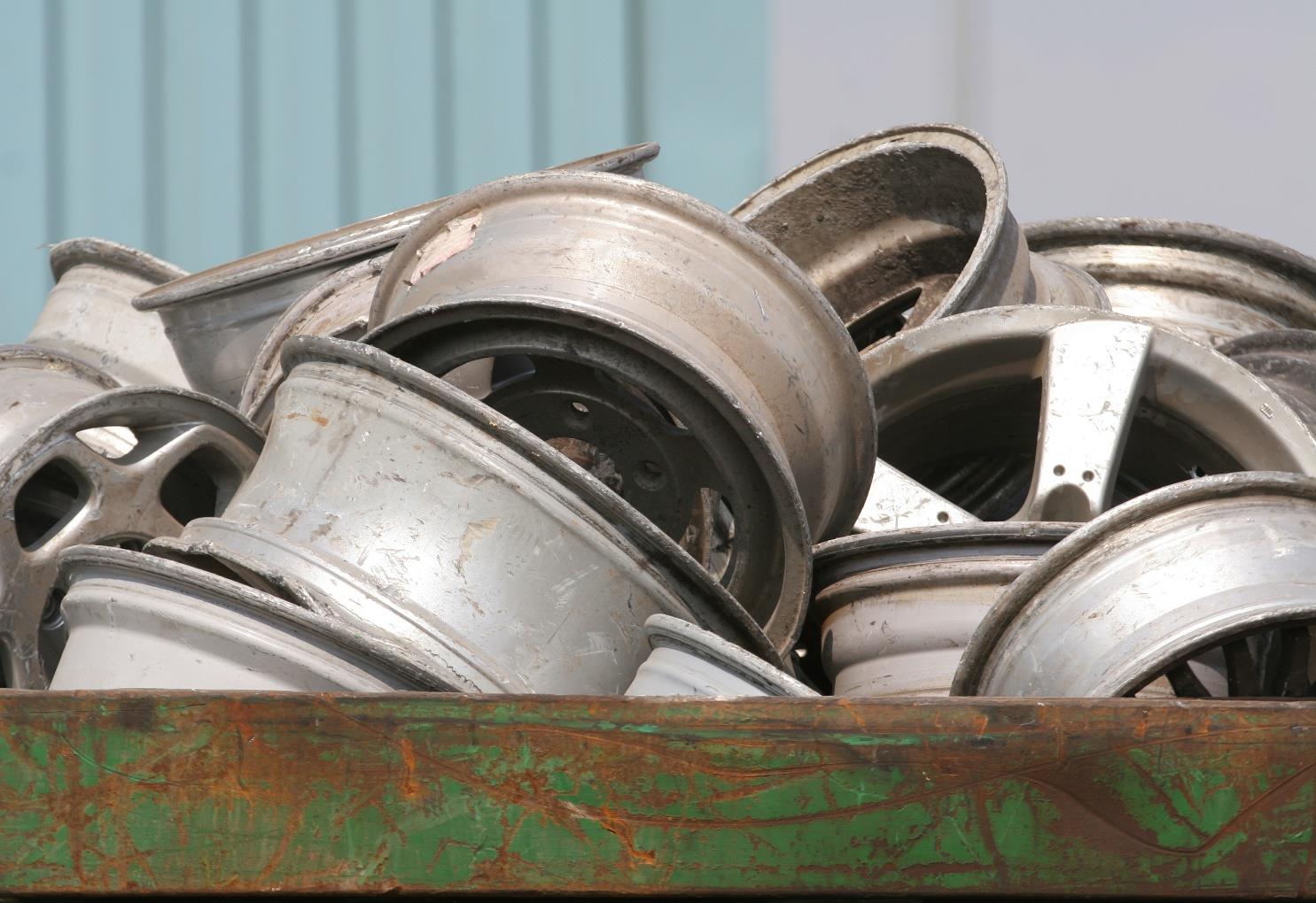 Pile of discarded metal wheel rims.