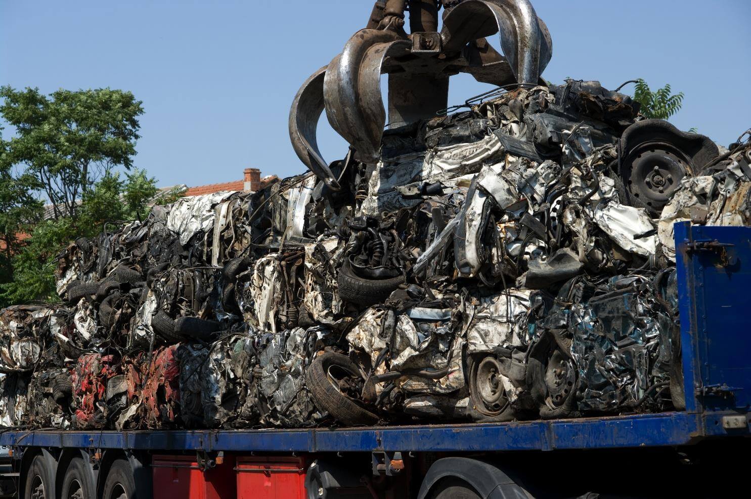 Crushed cars loaded on a large truck.